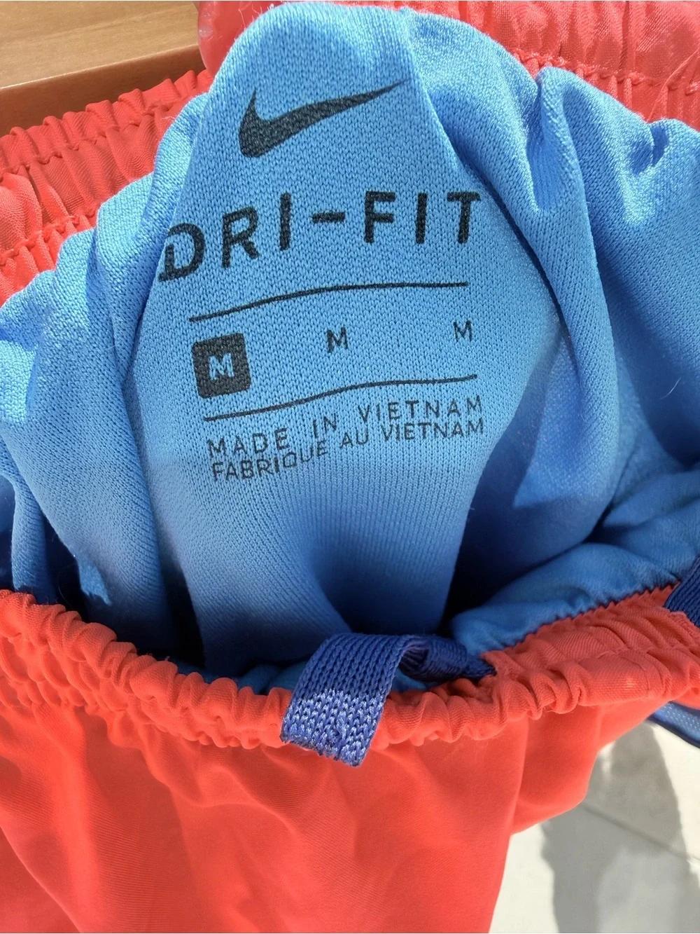 Nike Women's Coral Red Athletic Shorts with Blue Trim